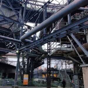 a large metal structure with lots of pipes